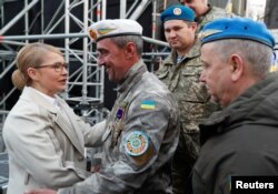 Presidential candidate Yulia Tymoshenko is greeted by soldiers during her last campaign rally in central Kyiv, Ukraine, March 29, 2019.