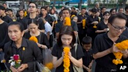 Para pelayat berbaris di depan potret mendiang Raja Thailand Bhumibol Adulyadej untuk memberikan penghormatan di luar kediaman resmi keluarga kerajaan, Grand Palace, di Bangkok, Thailand, 13 Oktober 2017. 