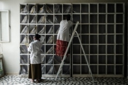 FILE - Staff members put files on shelves at the Ayder referral hospital in Mekelle, June 24, 2021.