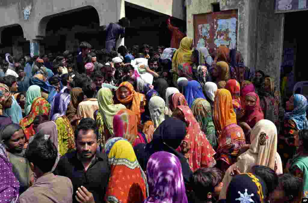 Victims of the unprecedented flooding from monsoon rains wait for relief aid, in Jaffarabad, a district of Pakistan's southwestern Baluchistan province, Sept. 4, 2022.