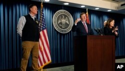 Mississippi Gov. Tate Reeves, center, announces the state imposed boil-water notice has been lifted in Jackson after nearly seven weeks, with Mississippi Emergency Management Agency executive director Stephen C. McCraney, right, and ASL interpreter Denee Smith, Sept. 15, 2022.