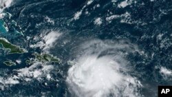 This satellite image provided by NOAA shows Tropical Storm Fiona in the Caribbean, Sept. 17, 2022.