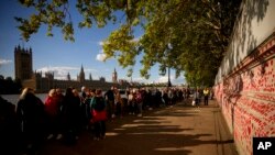People queue to pay their respects to the late Queen Elizabeth II, who is lying in state at Westminster Hall in London, Sept. 16, 2022.