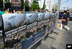Poster yang menunjukkan presiden terpilih Korea Selatan Yoon Suk Yeol mengecam kebijakan Korea Utara di sebuah jalan di Seoul, Korea Selatan, 27 April 2022. (Foto: AP)