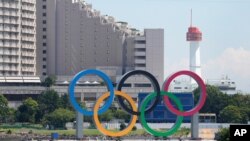 The Olympic rings float on a barge ahead of the 2020 Summer Olympics, July 19, 2021, in Tokyo.