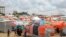 Somali children who fled drought-stricken areas stand by their makeshift shelters at a camp for the displaced on the outskirts of Mogadishu, Sept. 3, 2022. 