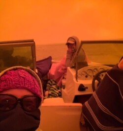 People evacuating on boat in Mallacoota, Victoria, are seen is this still image from a Dec. 31, 2019 social media video. (INSTAGRAM @IDASHOPE4STROKE via Reuters)