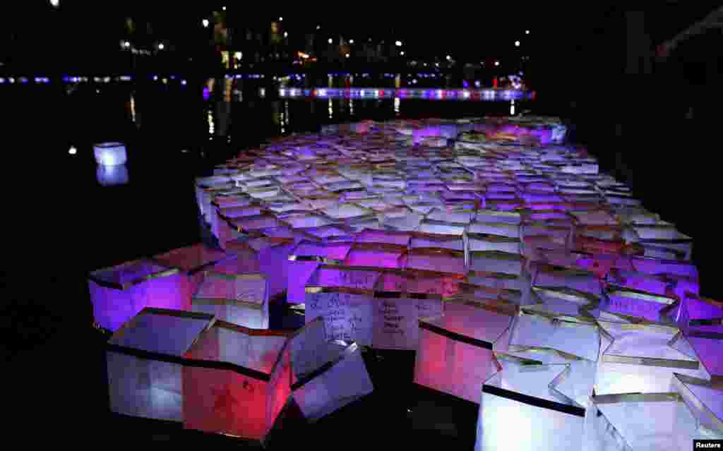 People release floats lit with candles on the Canal Saint-Martin, in Paris, France, after ceremonies held for the victims of last year&#39;s Paris attacks which targeted the Bataclan concert hall as well as a series of bars and killed 130 people.