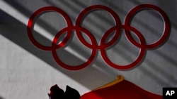 A man walking inside of the Zhangjiakou National Ski Jumping Center, Feb. 2, 2022, in Zhangjiakou, China.