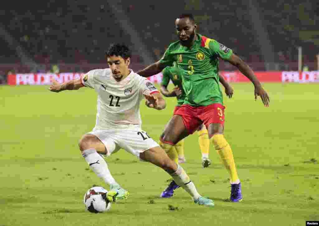 Egypt&#39;s Omar Marmoush in action with Cameroon&#39;s Nicolas Moumi Ngamaleu, Feb. 3, 2022.