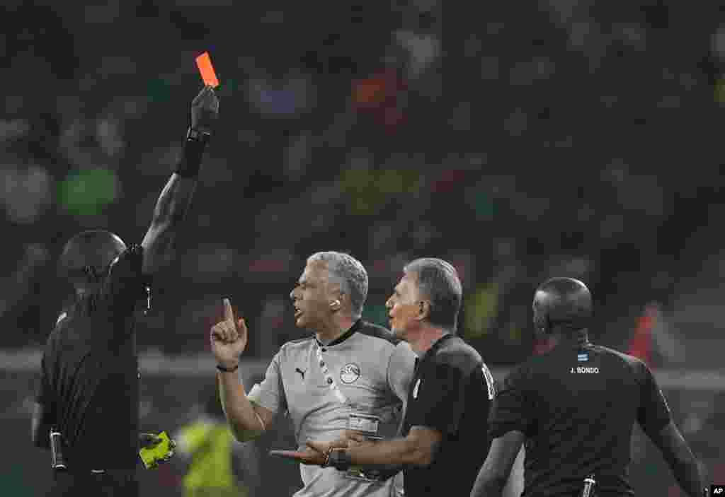 Egypt&#39;s head coach Carlos Queiroz, second right, is shown a red card by referee Gassama Bakary Papa of Gambia, Feb. 3, 2022.