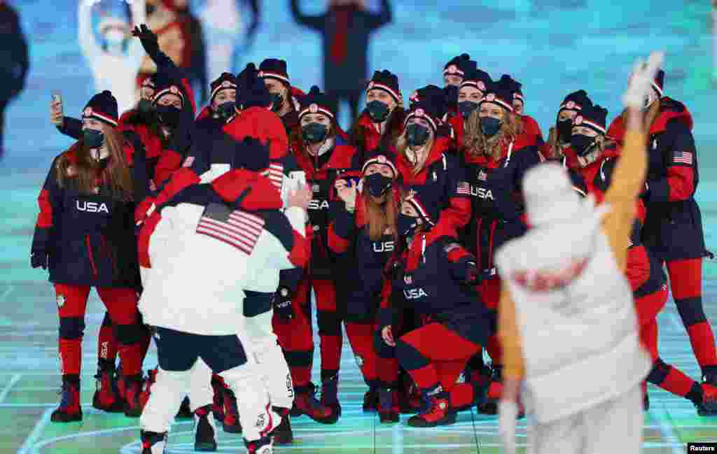 Members of the US team pose for a photo during the athletes parade at the opening ceremony.