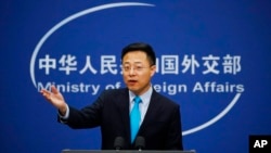 FILE - Chinese Foreign Ministry spokesman Zhao Lijian gestures as he speaks during a daily briefing at his ministry in Beijing, Feb. 24, 2020.