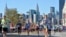 FILE - Runners make their way down 44th Drive in the Queens borough of New York during the New York City Marathon on Sunday, Nov. 6, 2011.