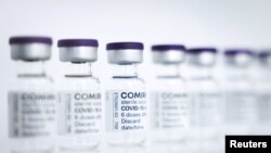 FILE - Empty vials to be filled with the Pfizer/BioNTech Comirnaty COVID-19 vaccine are seen at a production facility in Reinbek, near Hamburg, Germany, April 30, 2021.