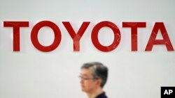  A visitor walks through a Toyota showroom in Tokyo, Aug. 3, 2018. 