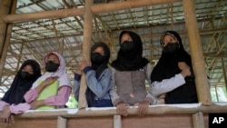Students wearing face masks as precaution against the coronavirus wait during class at the Nurul Fattah Islamic Boarding School in Tangerang, Indonesia, Monday, Feb. 7, 2022. (AP Photo/Tatan Syuflana)