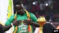 Senegal's forward Sadio Mane looks at the trophy prior to the ceremony after winning after the Africa Cup of Nations (CAN) 2021 final football match between Senegal and Egypt at Stade d'Olembe in Yaounde, Cameroon, on Feb. 6, 2022.
