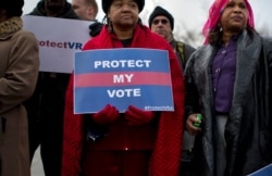 FILE - People wait in line outside the Supreme Court in Washington, Feb. 27, 2013, to listen to oral arguments in the Shelby County, Ala., v. Holder voting rights case.