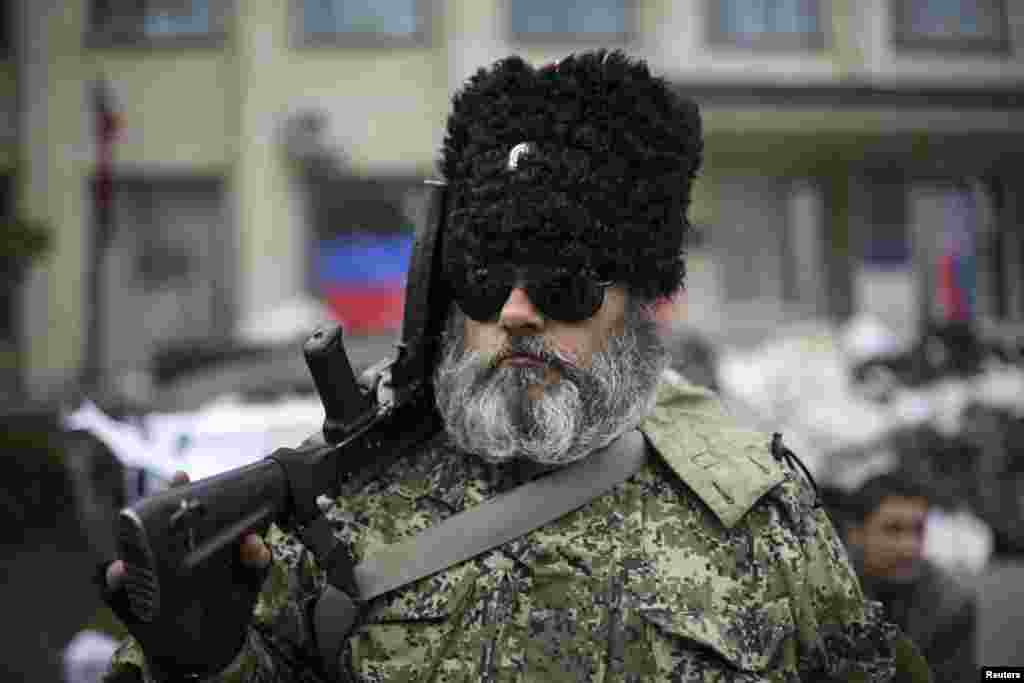 A pro-Russian armed man stands guard outside a regional government building seized by the pro-Russians, in Kramatorsk, eastern Ukraine, April 22, 2014.
