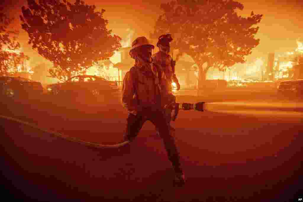 Firefighters battle the Palisades Fire as it burns multiple structures in the Pacific Palisades neighborhood of Los Angeles, Jan. 7, 2025.