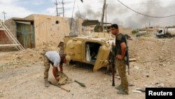 A girl poses in her graduation outfit in poppy fields near the Antelope Valley California Poppy Reserve in Lancaster, California.