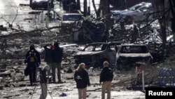 Investigators work near the site of an explosion on 2nd Avenue that occurred the day before in Nashville, Tennessee, U.S. December 26, 2020. 