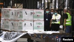 Workers transport Moderna vaccines against the COVID-19 shipped from the United States, to Taiwan Air Cargo Terminal at the Taoyuan International Airport in Taoyuan, Taiwan, June 20, 2021. 