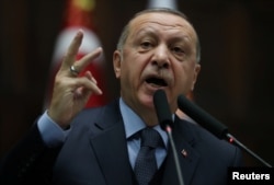 Turkish President Tayyip Erdogan addresses members of parliament from his ruling AK Party (AKP) during a meeting at the Turkish parliament in Ankara, Turkey, Jan. 8, 2019.