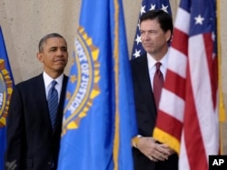FILE - President Barack Obama stands with James Comey during the presentation of colors at Comey's installation as FBI Director, Oct. 28, 2013, at FBI Headquarters in Washington.