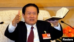 Zhou Yongkang gestures as he speaks at a group discussion of Shaanxi Province during the National People's Congress at the Great Hall of the People in Beijing, March 12, 2011.