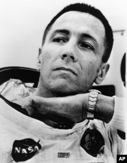 Astronaut John Swigert adjusts something inside his space suit at the Kennedy Space Center Saturday, April 11, 1970, as the Apollo 13 astronauts suited up for their lunar flight. Swigert took the place of Thomas Mattingly as the command module pilot.