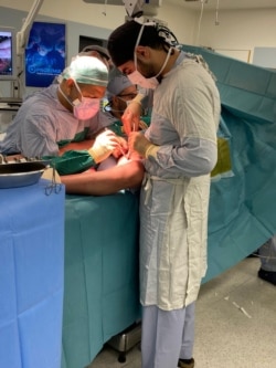 Dr. Bassam Osman (right) working under the supervision of his mentor, Dr. Jamil Borgi (far back of the photo). (Courtesy photo from Dr. Bassam Osman)
