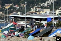 FILE - A camp is set up by migrants, at the Franco-Italian border in Ventimiglia, Italy, June 20, 2015.