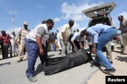 Relatives carry the body of a farmer killed in an attack by Somali forces supported by U.S. troops in the Lower Shabelle region of Somalia, Aug. 25, 2017.