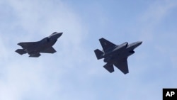 FILE - Two F-35 jets arrive at Hill Air Force Base in northern Utah, Sept. 2, 2015.