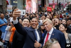Impersonators of North Korean leader Kim Jong Un, former U.S. President Barack Obama and U.S. President Donald Trump take selfies in Hong Kong on July 4, 2017.