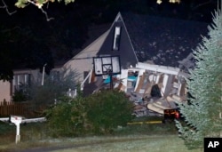 A house is destroyed, Sept. 13, 2018, in Lawrence, Mass.