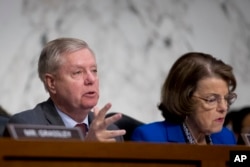 Senate Judiciary Committee Chairman Lindsey Graham, flanked by Ranking Member Sen. Dianne Feinstein questions Attorney General nominee William Barr during a Senate Judiciary Committee hearing on Capitol Hill in Washington, Jan. 15, 2019.