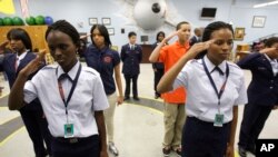 Baltimore Polytechnic Institute Air Force Junior ROTC cadets salute while practicing drills, Thursday, Nov. 12, 2009, in Baltimore. (AP Photo/Rob Carr)