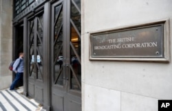 FILE - A man enters the headquarters building of the British Broadcasting Corporation (BBC), in London, Britain, July 19, 2017.
