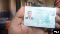 An ethnic Pashtun shows his ID card in Bajaur, Pakistan. Pashtuns say they are being harassed by police and undergoing racial profiling.