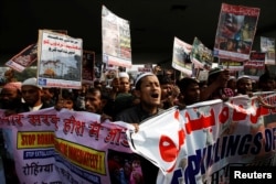 Rohingya Muslim refugees shout slogans during a protest against what organizers say is the crackdown on ethnic Rohingyas in Myanmar, in New Delhi, India, Dec. 19, 2016.