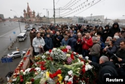 People gather at the site where Boris Nemtsov was recently murdered, with St. Basil's Cathedral seen in the background, in central Moscow, Feb. 28, 2015.