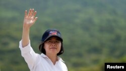 FILE - Taiwanese President Tsai Ing-wen waves after the annual Han Kuang military drill simulating the China's People's Liberation Army (PLA) invading the island, in Pingtung county, southern Taiwan, Aug. 25, 2016.