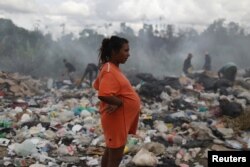 Venezuelan Astrid Prado, who is 8 months pregnant, is seen at a garbage dump in the border city of Pacaraima, Brazil, April 13, 2019.