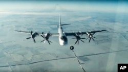 FILE - A Tu-95 strategic Russian bomber is in flight over Syria, from footage taken from Russian Defense Ministry official website, Nov. 17, 2016.