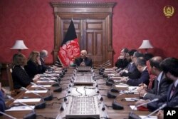 FILE - In this photo released by the Afghan Presidential Palace, Afghan President Ashraf Ghani, center, speaks to U.S. peace envoy Zalmay Khalilzad, third left, at the presidential palace in Kabul, Afghanistan, Jan. 28, 2019.