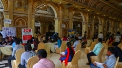 FILE - Candidates wait to attend interviews during a job fair conducted by Hyderabad city police in Hyderabad, India, July 24, 2021.
