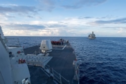 The Arleigh Burke-class guided-missile destroyer U.S.S. Dewey prepares for a replenishment-at-sea in the South China Sea on May 19, 2017.